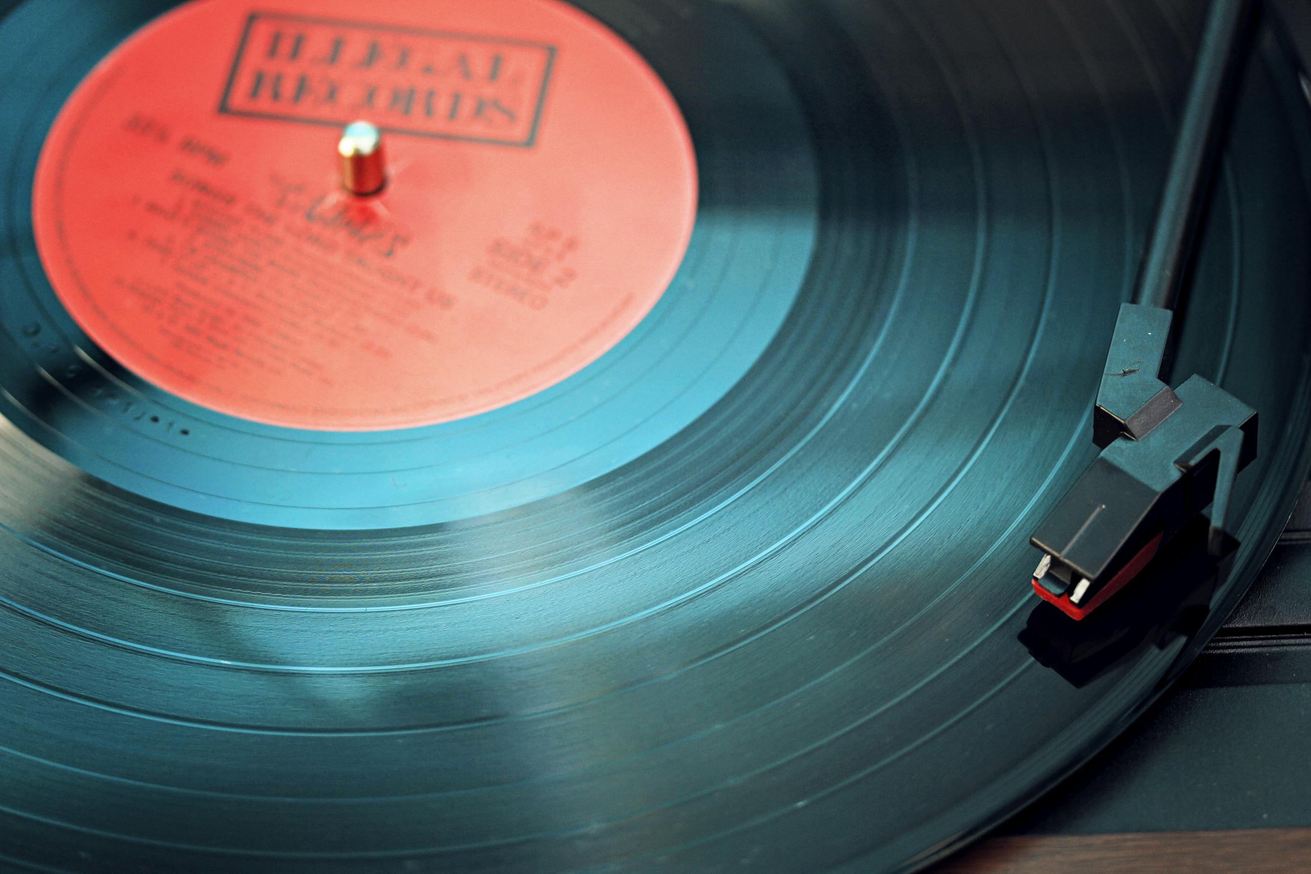 A detailed close-up view of a vintage vinyl record spinning on a turntable, capturing its nostalgic beauty.